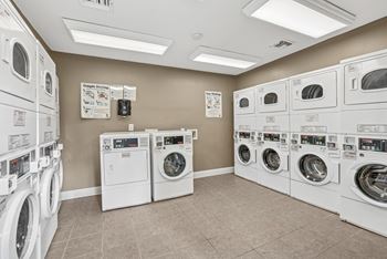 A laundromat with rows of washers and dryers.